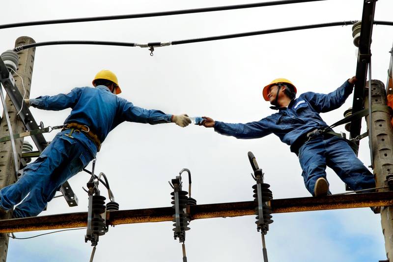 Line workers on a utility pole