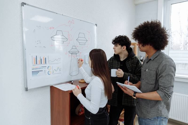 Colleagues planning together at a whiteboard